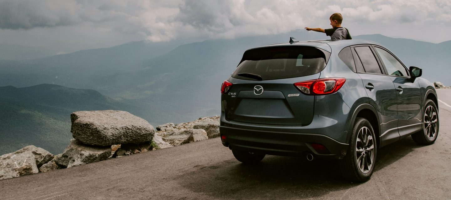 A brand new car on a mountain road