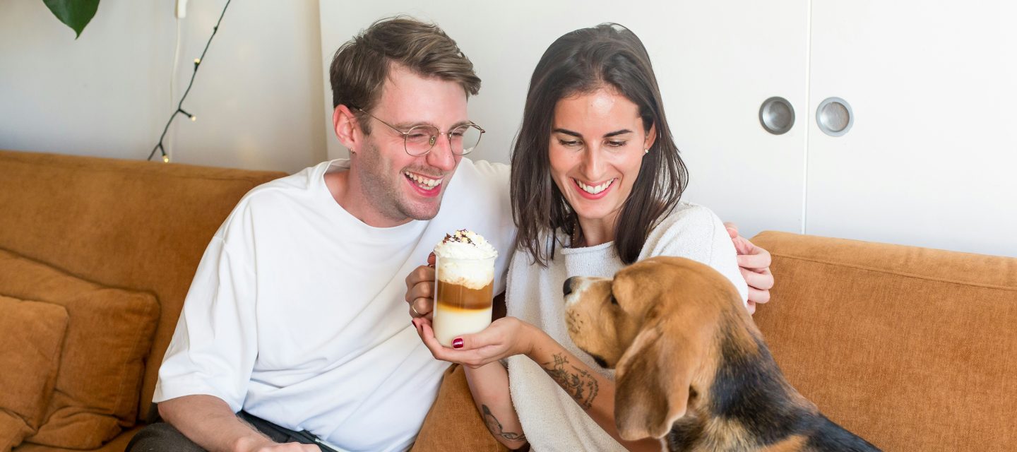 A couple relaxing at home with their dog